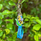 A bee riding a leaf holographic acrylic keychain, with a lanyard that says "bee leaf in yourself