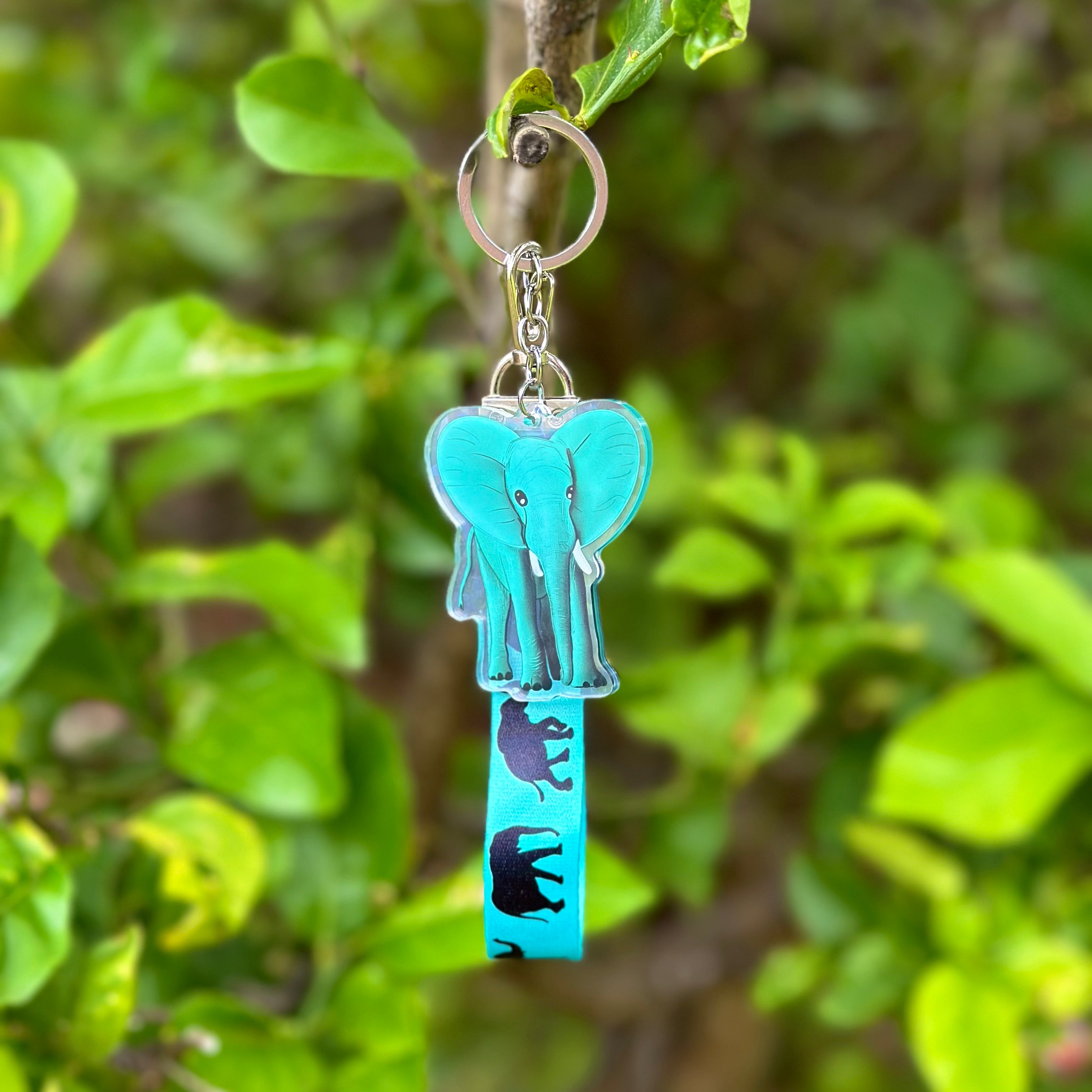 Blue Elephant Acrylic Holographic Keychain, with a matching blue Lanyard that has black elephants marching