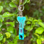 Blue Elephant Acrylic Holographic Keychain, with a matching blue Lanyard that has black elephants marching