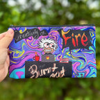 Creatively on Fire or just burnt out Pouch, featuring an individual with strained eyes and wild hair sitting behind a laptop