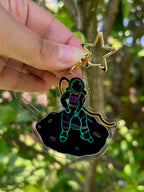 Lonely Falling Spaceman Acrylic Keychain pghoto taken outdoors