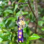 Golden Retriever Treasure Dog Acrylic Holographic keychain, hung with a purple and glowing yellow paws Lanyard
