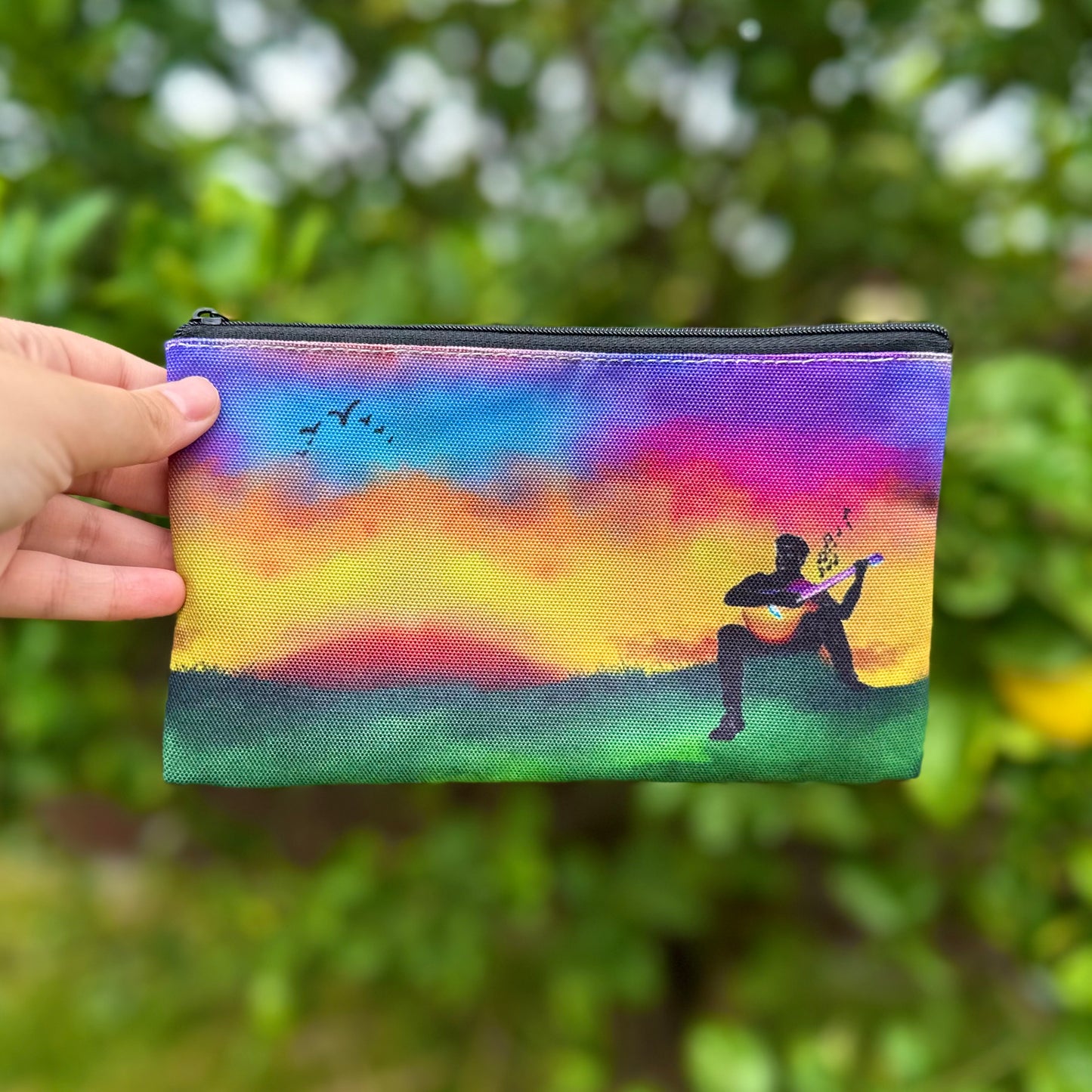 Guitarist in a field of Rainbow Pouch