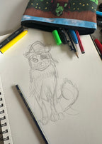 Art supplies including a pencil case, markers, and a drawing of a character on a piece of paper.