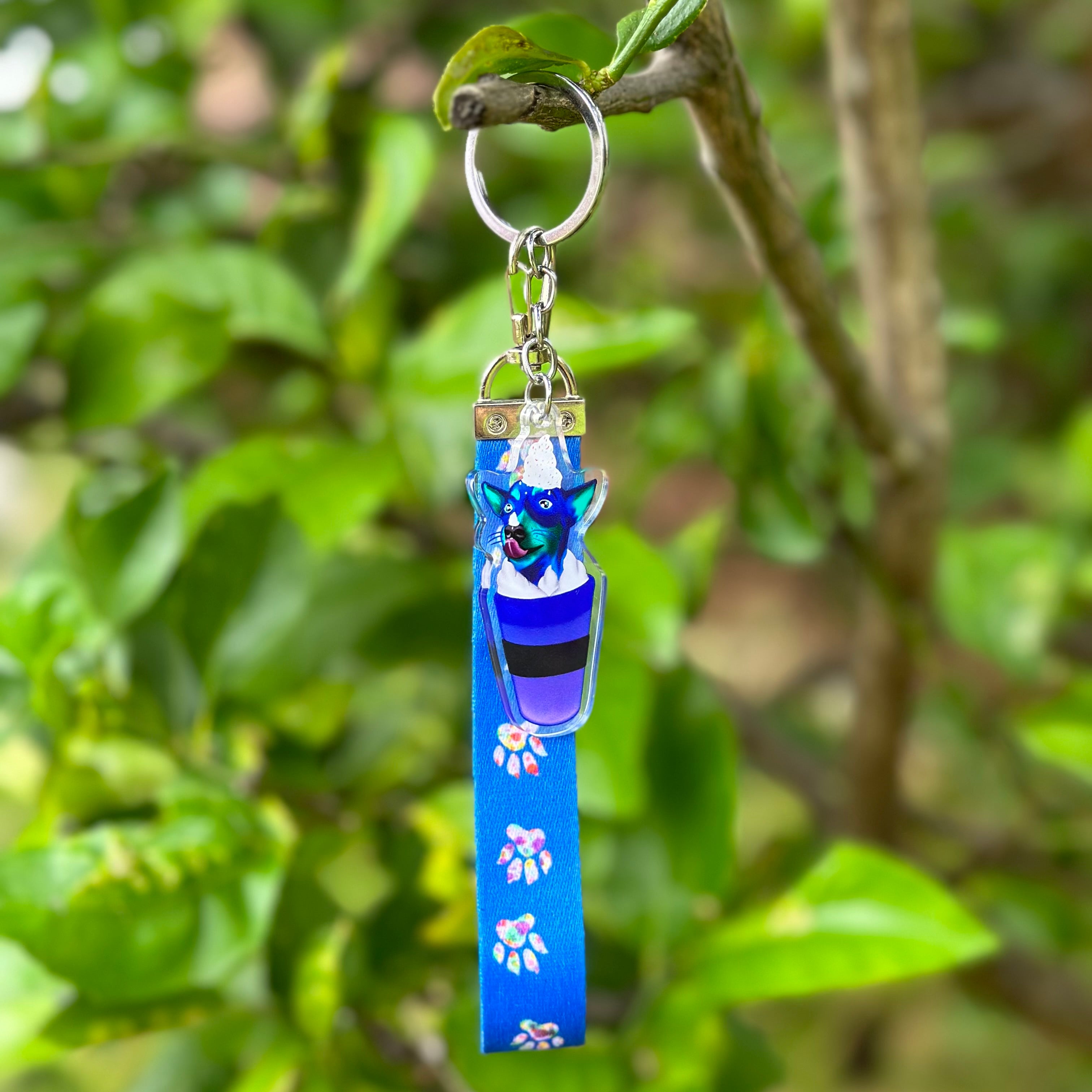 Blue Jack Russell Rok in a Pup Cup Acrylic Holographic Keychain, with a blue and white paws Lanyard