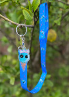 A blue bubblegum Ice Cream wearing a silver crown accompanies by a long blue necklanyard with pink sprinkles and repeat bubblegum Ice Cream Print
