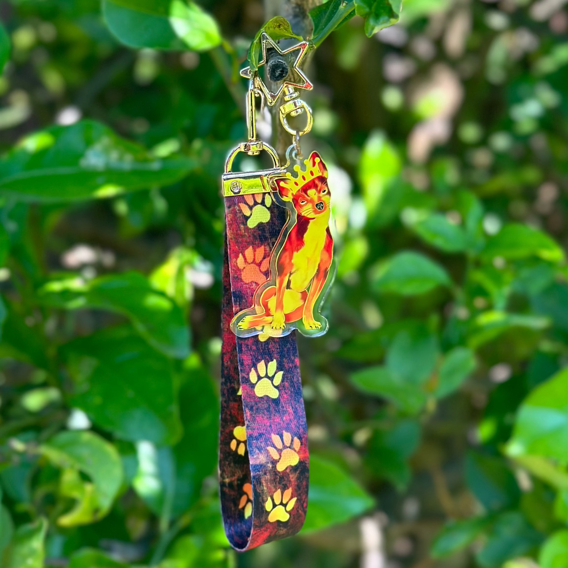 Queen Chihuahua Fiery Crown Acrylic Keychain with a fiery lanyard that features fire dog paws 