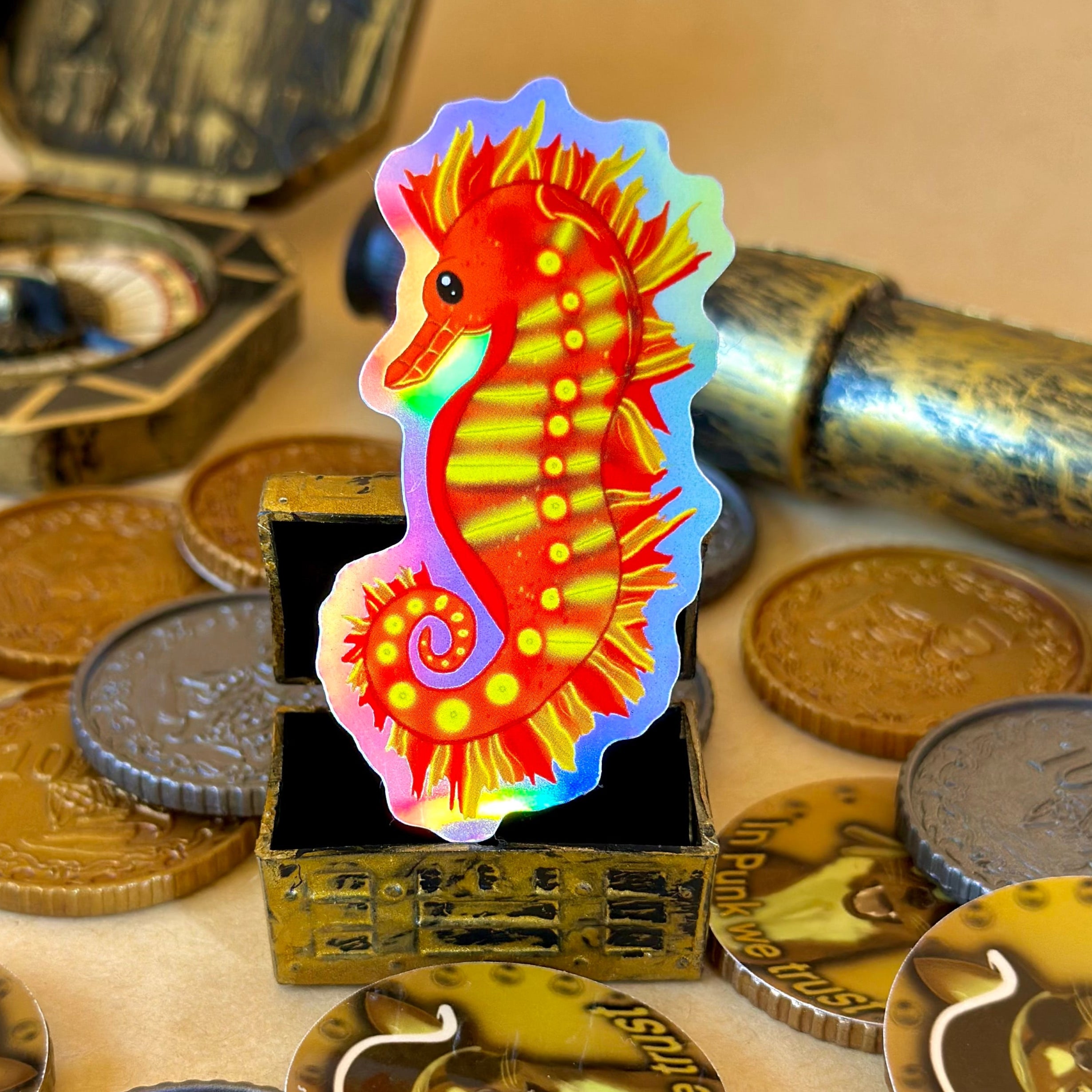 Scarlet the Fiery Seahorse Holographic Sticker surrounded by treasure