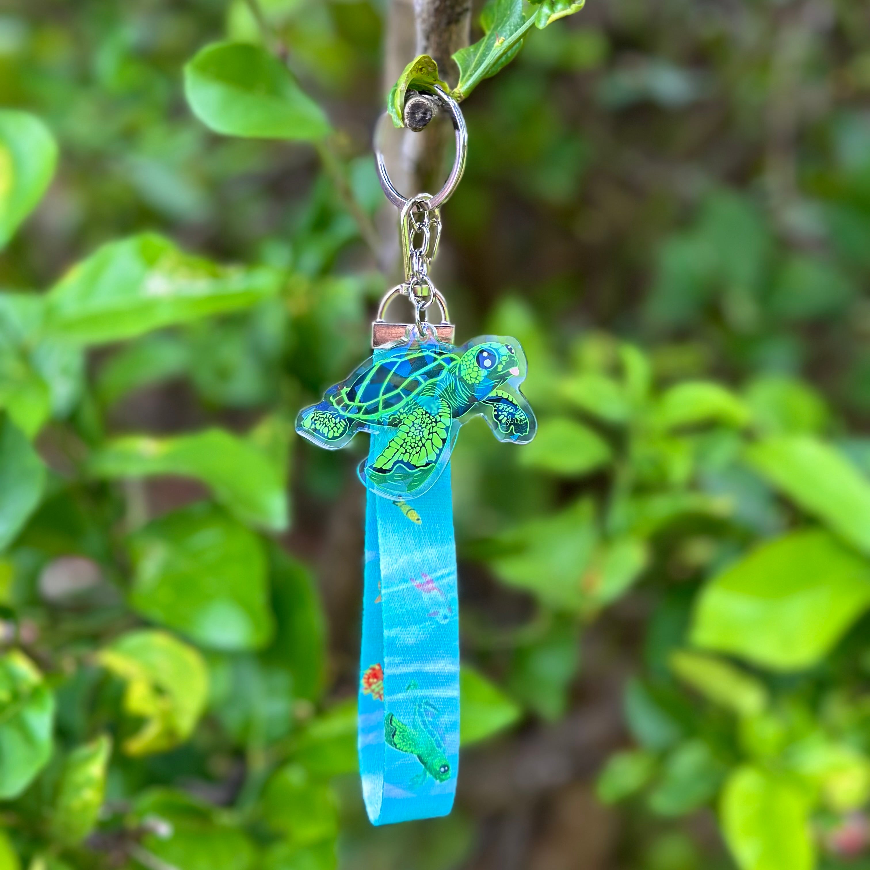 Cute Sea Turtle with it's Tongue Poking Out Acrylic Holographic Keychain, with a Lanyard full of ocean animals like fish seahorse and turtles. 