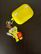 Cute Yellow Bear Acrylic Keychain on some AirPods