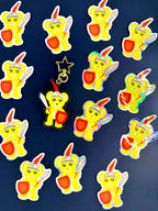 Cute Yellow Bear holding Sword and shield Acrylic Keychain surrounded by holographic Stickers