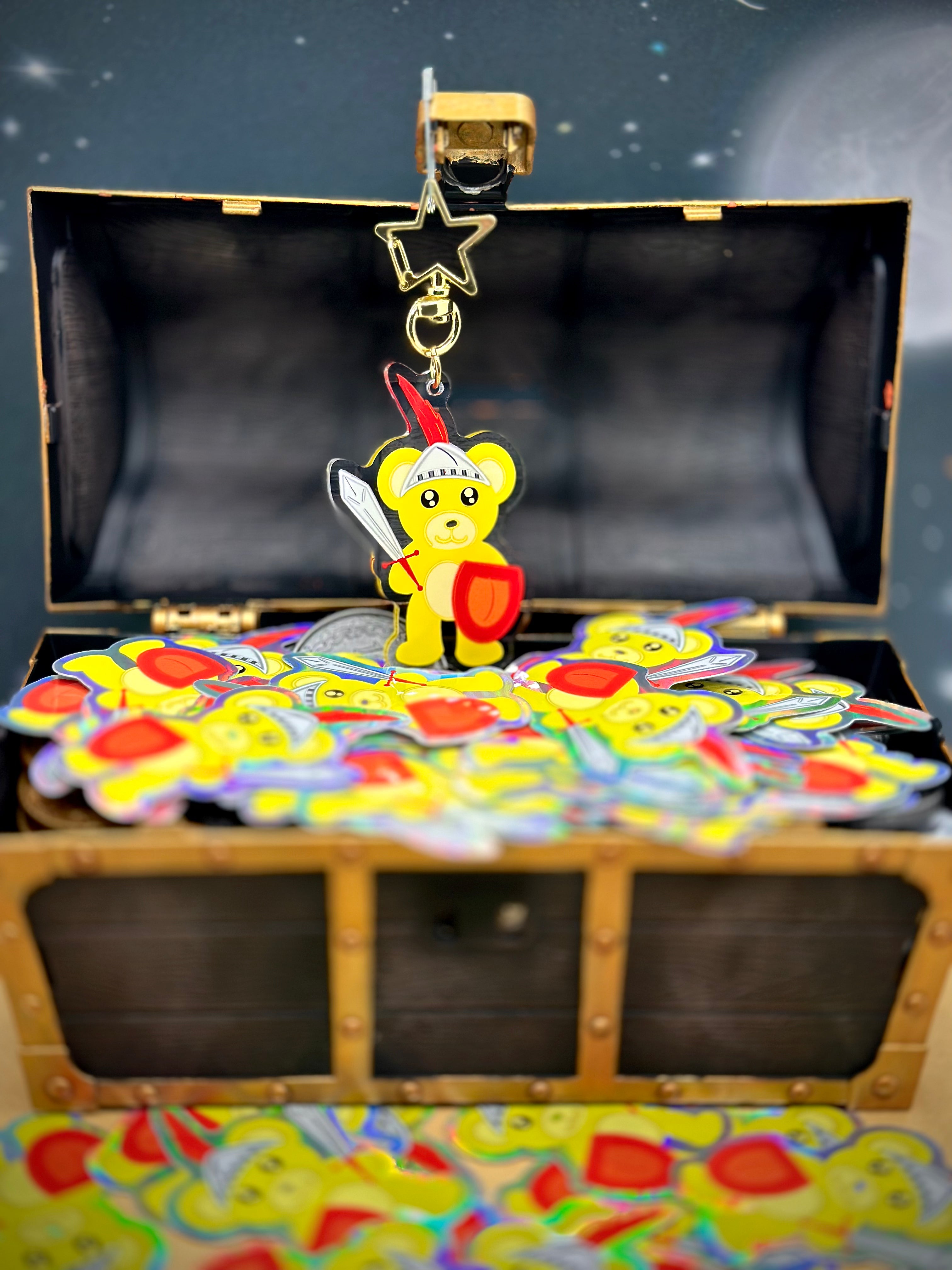 Cute Yellow Bear Acrylic Keychain Standing over Yellow Bear Holographic Stickers in a treasure Chest