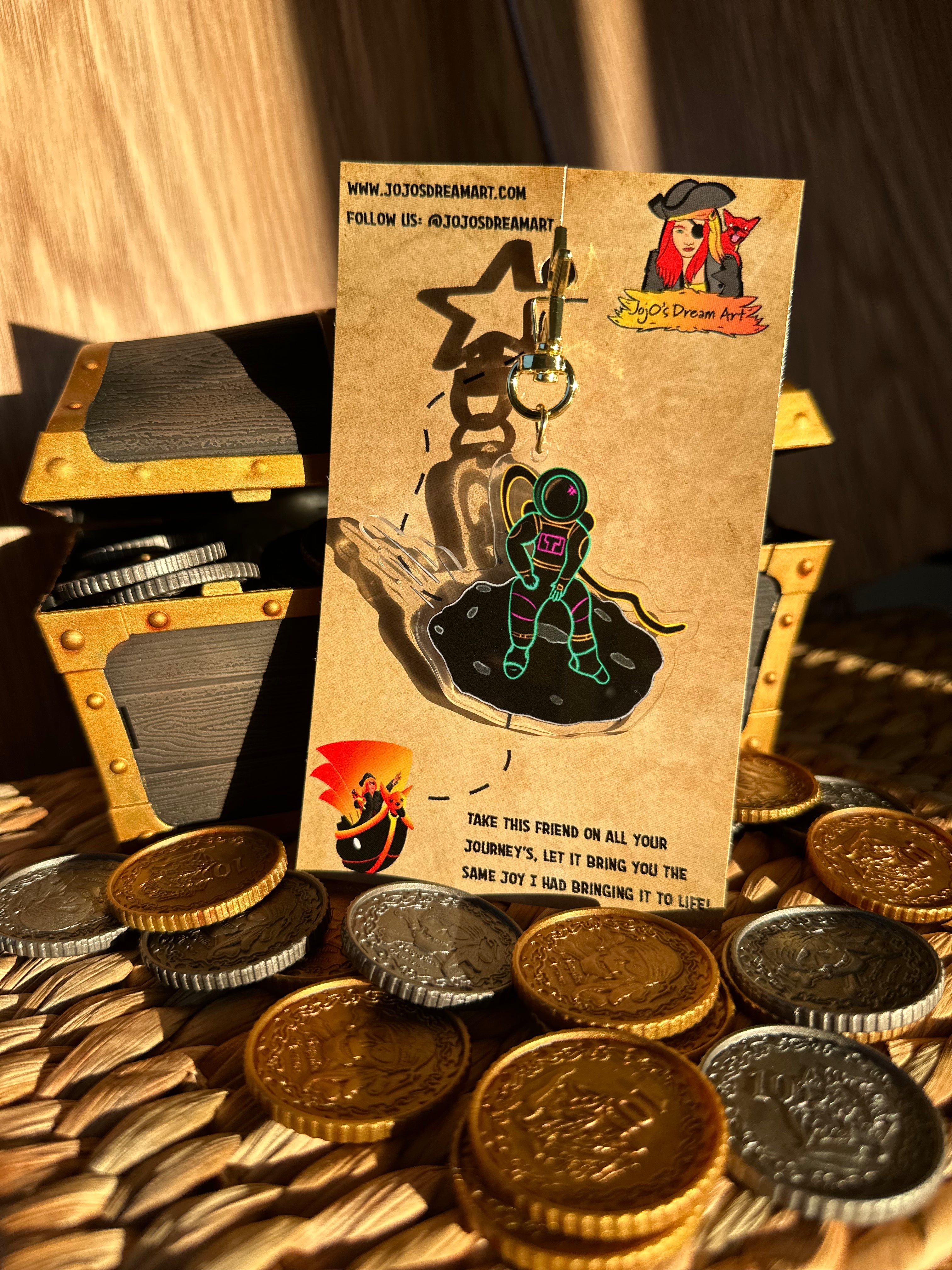 Spaceman Acrylic Keychain surrounded by treasure