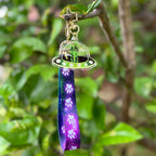 Stella the Space Dachshund Acrylic Keychain with a space Lanyard that has white paws