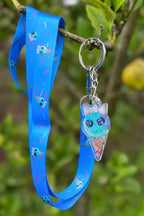 A blue bubblegum Ice Cream wearing a silver crown accompanies by a long blue necklanyard with pink sprinkles and repeat bubblegum Ice Cream Print